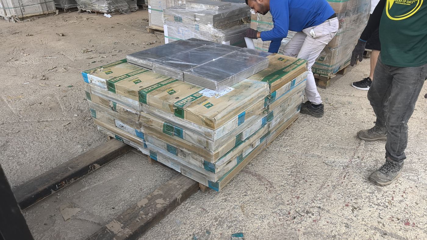 XXL Space Share crew stacking and wrapping tiles on a pallet for order fulfillment